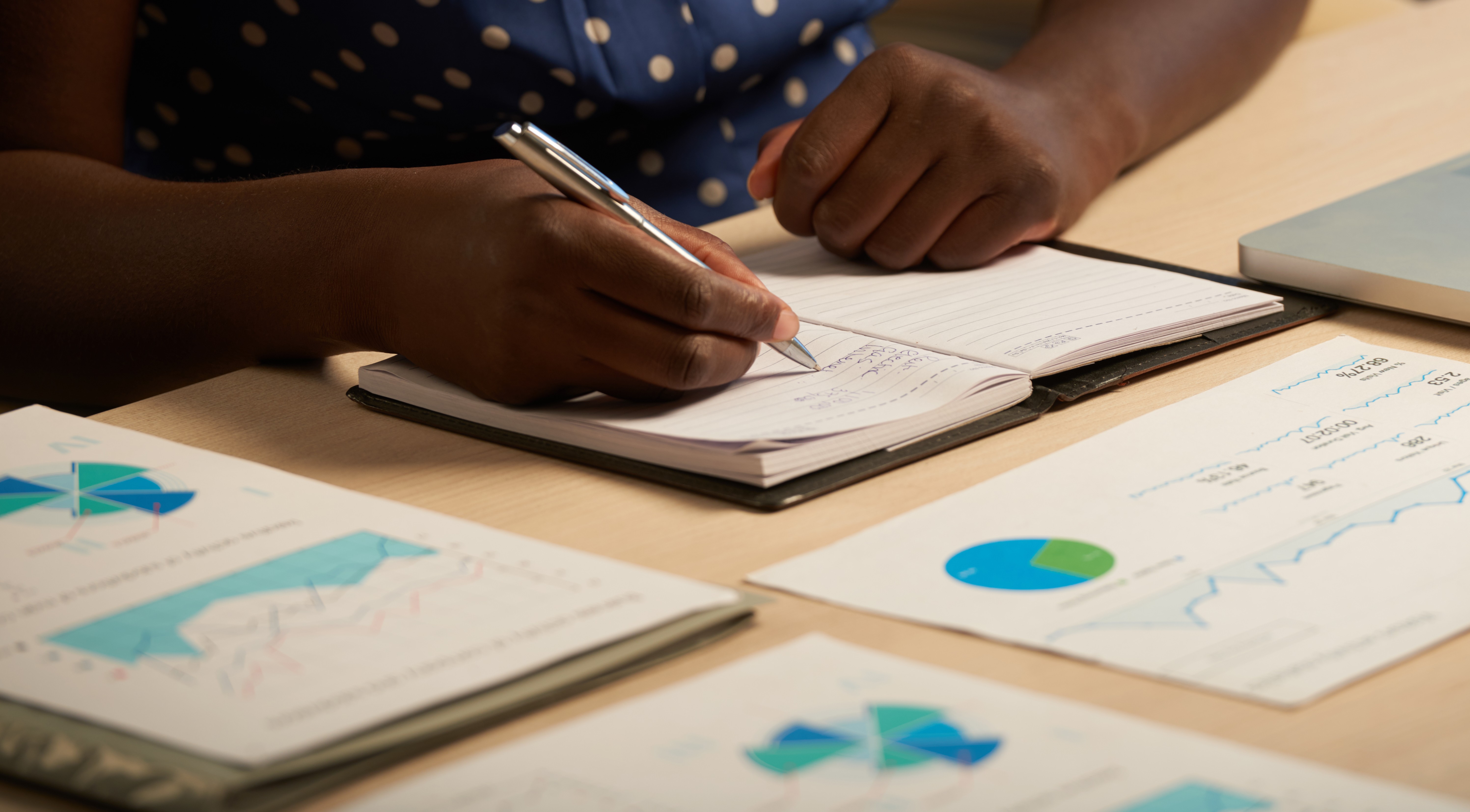 Cropped image of business lady taking notes in her planner